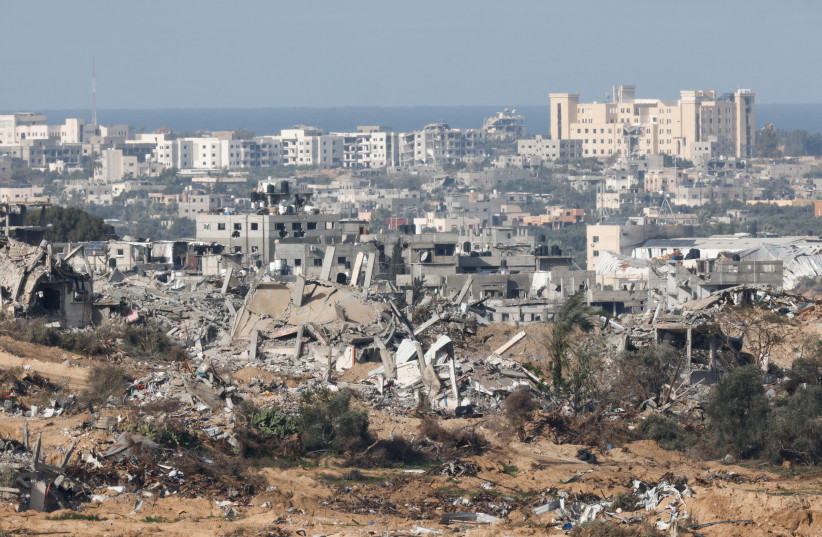 Destroyed buildings lie in ruin in central Gaza, amid the ongoing conflict between Israel and the Palestinian Islamist group Hamas, near the Israel-Gaza border, as seen from Israel, January 13, 2024. (credit: REUTERS/AMIR COHEN)