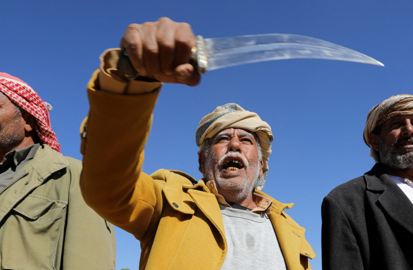  A tribal supporter of Yemen's Houthis hold his traditional dagger, or jambiya, during a protest against recent U.S.-led strikes on Houthi targets, near Sanaa, Yemen January 14, 2024 (credit: REUTERS/Khaled Abdullah TPX IMAGES OF THE DAY)
