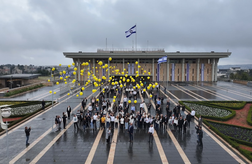  Knesset workers release 136 balloons to signify the hostages in captivity, January 14, 2024 (credit: NOAM MOSHKOWITZ/KNESSET SPOKESPERSON)