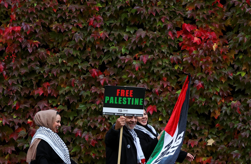  Pro-Palestinian protesters pose with autumn foliage in the background near the rally held in solidarity with Palestinians in Gaza, amid the ongoing conflict between Israel and the Palestinian Islamist group Hamas, in London, Britain, November 4, 2023.  (credit: REUTERS/TOBY MELVILLE)