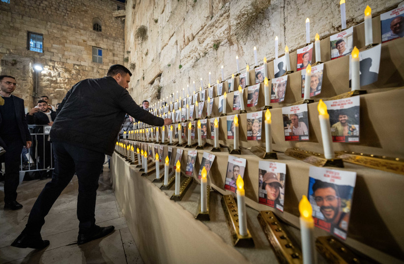 People light the Hanukkah candles for the release of Israelis kidnapped in the Gaza Strip by Hamas terrorists at the Western Wall, December 7, 2023. (credit: YONATAN SINDEL/FLASH90)