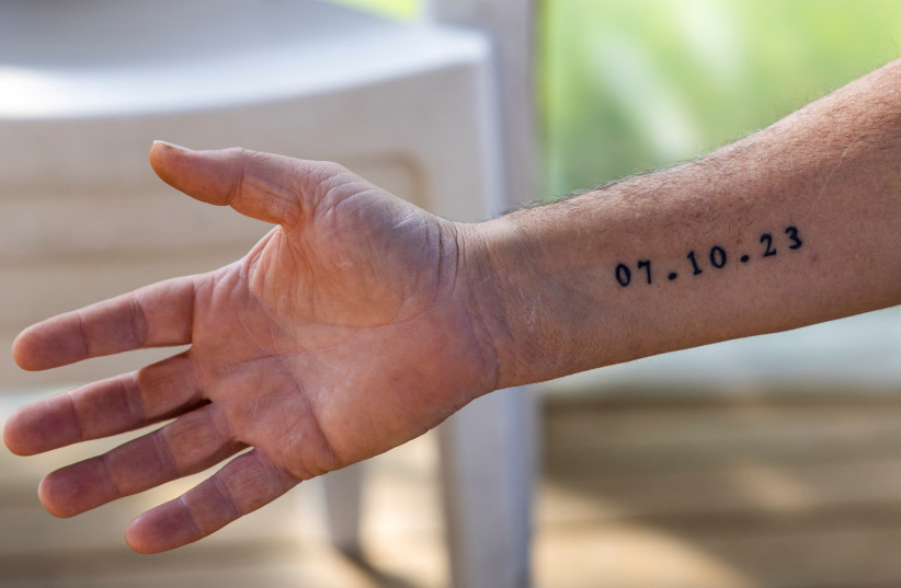  The arm of Shar Shnurman with a tattoo of the date 07.10.2023, January 13, 2024 (credit: REUTERS/AMIR COHEN)