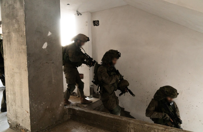  IDF combat soldiers shortly after finding a slew of weapons in a child's bedroom in Gaza. (credit: IDF SPOKESPERSON UNIT)