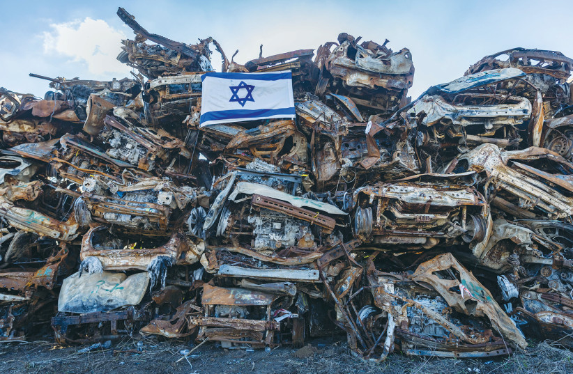  CARS DESTROYED by Hamas during the October 7 massacre are piled high in a field near the Israel-Gaza border. (credit: Chaim Goldberg/Flash90)