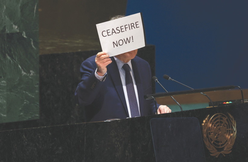  PALESTINIAN UN envoy Riyad Mansour holds up a sign calling for an immediate ceasefire in Gaza, as he speaks in the General Assembly Hall at UN headquarters in New York City, last week. The UN is losing its relevance fast, the writers argue. (credit: Shannon Stapleton/Reuters)