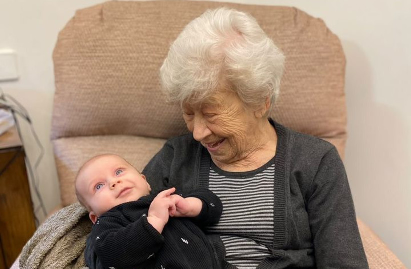  Greta Monk holds her great-great-grandson, Ivri Menahem. (credit: sivanrahavmeir.com)