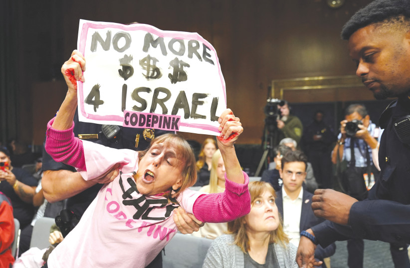  A PROTESTER is removed during a US Senate Appropriations Committee hearing on President Biden's supplemental funding request for Israel and Ukraine, in October. The Gaza war has implications for inter-power relations in various contexts such as the war in Ukraine, the writer notes. (credit: KEVIN LAMARQUE/REUTERS)