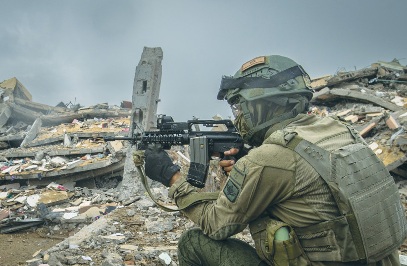  An IDF Paratroopers Brigade soldier operates in the Gaza Strip, earlier this month. (credit: OREN BEN HAKOON/FLASH90)