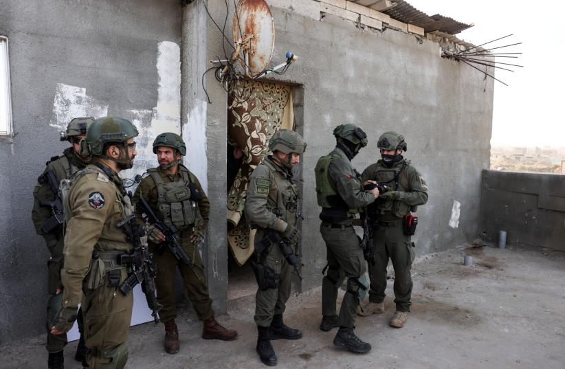 Israeli soldiers stand as they operate, amid the ongoing conflict between Israel and the Palestinian Islamist group Hamas, in Gaza, January 8, 2024. (credit: REUTERS/Ronen Zvulun)