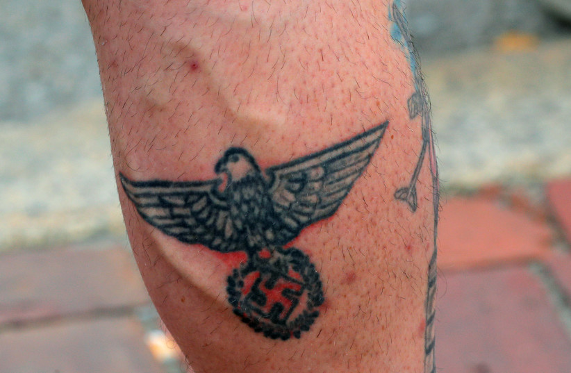  A man wearing a “Nationalist Social Club 131” (NSC 131) shirt shows his swastika tattoo during a pro-police rally, following weeks of protests against racial inequality in the aftermath of the death in Minneapolis police custody of George Floyd, in Boston, Massachusetts, U.S. June 27, 2020. (credit: BRIAN SNYDER/REUTERS)