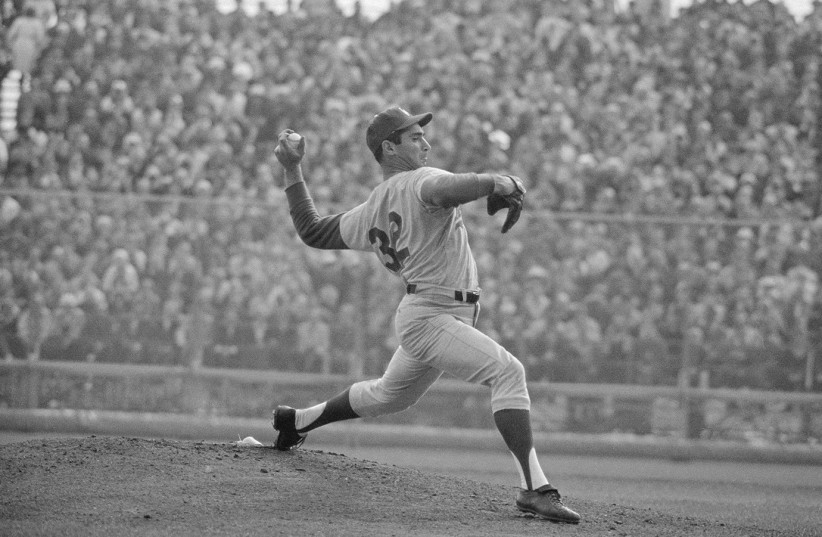  Sandy Koufax of Dodgers goes through his motions against Minnesota Twins here en route to a 3-hit shutout in the 1965 World Series to National League champions. (credit: (Bettmann/Contributor/Getty Images))