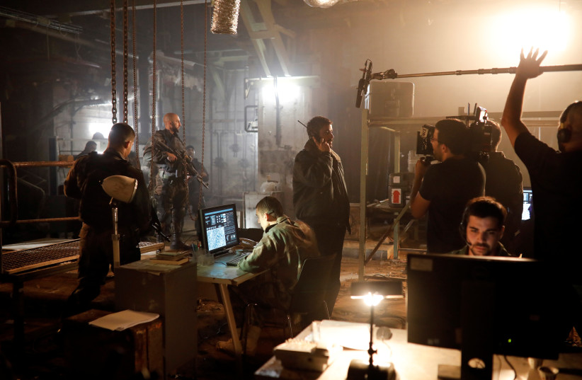  Actors and filming crew members work on the set of Israeli television series ''Fauda'' in Tel Aviv, Israel May 30, 2019. (credit: REUTERS/AMIR COHEN)