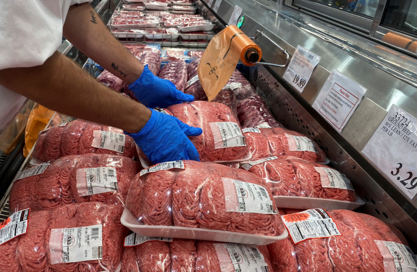  A worker stacks packets of ground beef in the meat section of a Costco warehouse  (credit:  REUTERS/Adrees Latif)