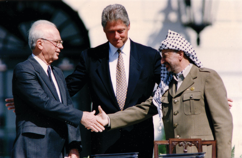  BILL CLINTON, Yitzhak Rabin, and Yasser Arafat, after the signing of the Israel-PLO Declaration of Principles at the White House in 1993: What’s troubling is the resignation that any renewed peace negotiation will be futile because everything that’s been tried before didn’t work, the writer laments (credit: GARY HERSHORN/REUTERS)