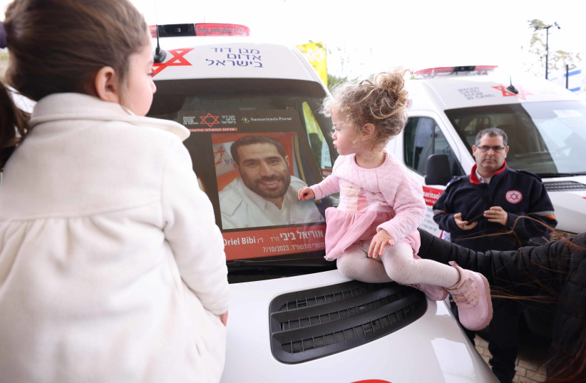  The children of MDA paramedic Oriel Bibi who fell in active service at the dedication of an ambulance in his memory, donated by Samaritan's Purse. (credit: Eastside studio)