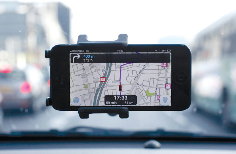  Waze, an Israeli mobile satellite navigation application, is seen seen on a smart phone in this illustrative photo taken in Tel Aviv. (credit: NIR ELIAS/REUTERS)