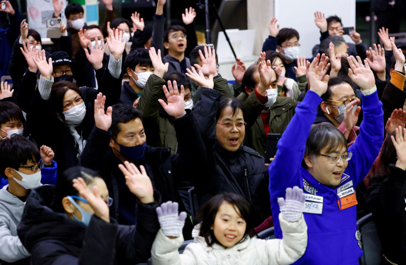  People raise their hands after a moon landing by the Smart Lander for Investigating Moon (SLIM), in a public viewing event in Sagamihara, south of Tokyo, Japan January 20, 2024. (credit: REUTERS/KIM KYUNG-HOON)