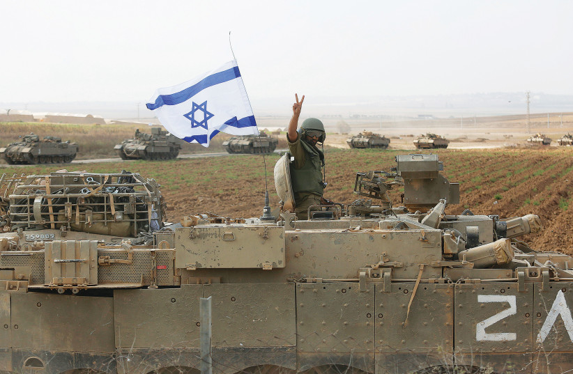  A SOLDIER poses atop a tank near the border with Gaza in October of last year.  (credit: Amir Levy/Getty Images)