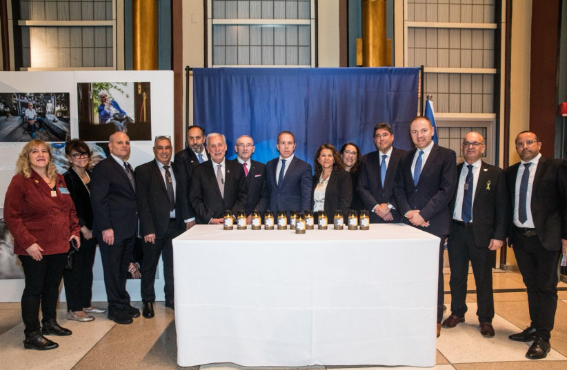  Ambassadors posing with Gilad Erdan in front of candles lit at the event.  (credit: ISRAELI DELEGATION TO THE UN)