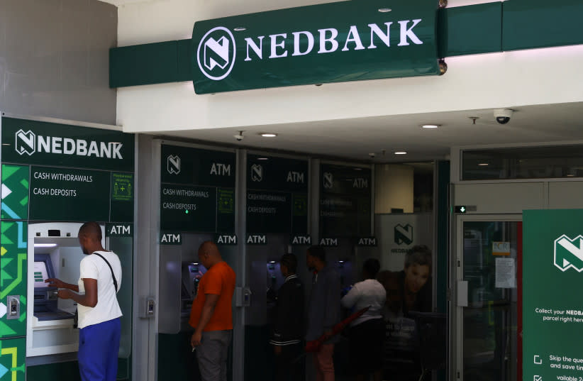  Clientes realizan transacciones en el cajero automático de Nedbank en el Trade Route Mall, en Lenasia, a las afueras de Johannesburgo, Sudáfrica, 8 de febrero de 2023. (credit: SIPHIWE SIBEKO/REUTERS)