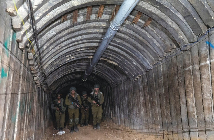  Soldados israelíes caminan a través de lo que, según las Fuerzas de Defensa de Israel, era un túnel de hierro diseñado por Hamás para desembarcar carros cargados de combatientes palestinos con el fin de asaltar por sorpresa la frontera, en el norte de la Franja de Gaza. (credit: AMIR COHEN/REUTERS)