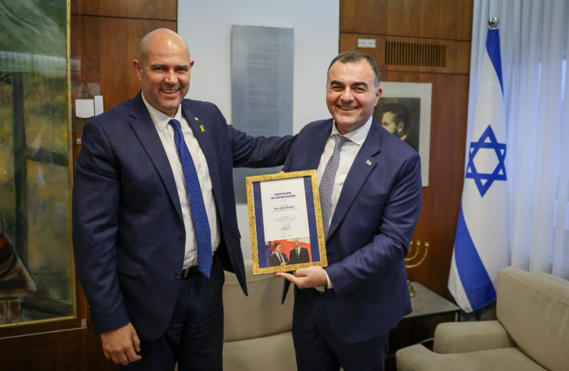  Knesset Speaker Amir Ohana receives a copy of the epic work The  Knight in the Panther's Skin from outgoing Georgian Ambassador Lasha Zhvania. (credit: COURTESY GEORGIAN EMBASSY)