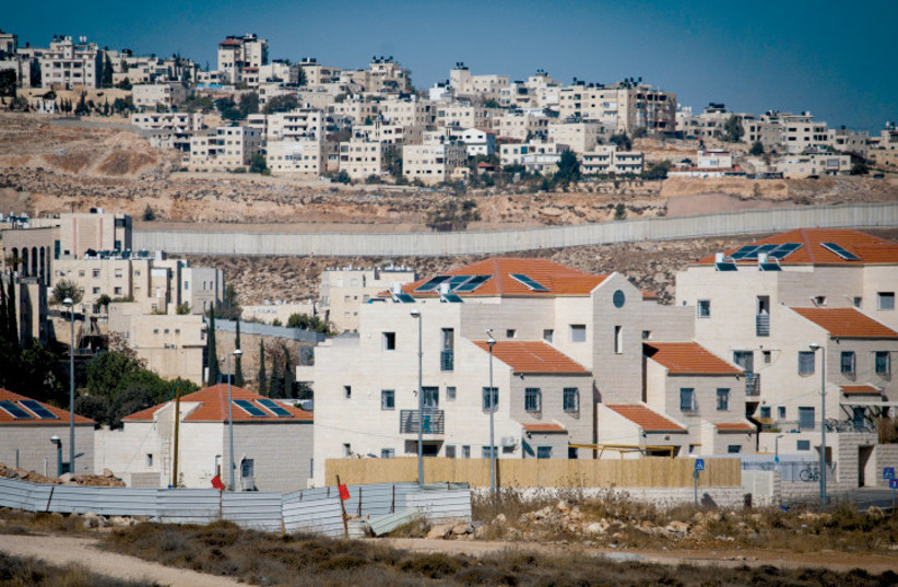  Newly constructed Jewish residential area in Pisgat Ze'ev, with security fence in background. (credit: FLASH90)