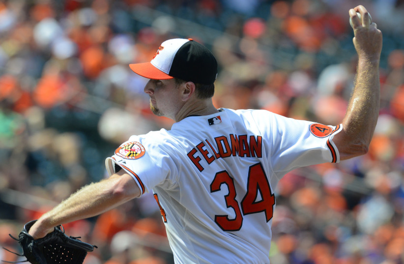  Baltimore Orioles starting pitcher Scott Feldman works against the Toronto Blue Jays into the eighth inning to pick up his first win as an Oriole during their MLB American League baseball game in Baltimore, Maryland July 14, 2013. (credit: REUTERS/Doug Kapustin)