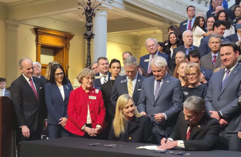  Gov. Kemp signs the antisemitism bill into law. Looking on, at far left, is IAC CEO Elan Carr.  (credit: IAC FOR ACTION)