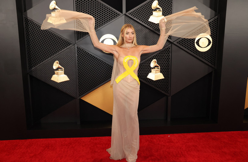  Montana Tucker poses on the red carpet as she attends the 66th Annual Grammy Awards in Los Angeles, California, US, February 4, 2024. Her outfit included a yellow ribbon symbolizing support for the 136 Israeli hostages held captive by Hamas in Gaza. (credit: REUTERS/MARIO ANZUONI)