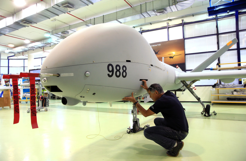 An employee checks an Elbit Systems Ltd. Hermes 900 unmanned aerial vehicle (UAV) at the company's drone factory in Rehovot, Israel, June 28, 2018. Picture taken June 28, 2018. (credit: REUTERS/OREL COHEN)