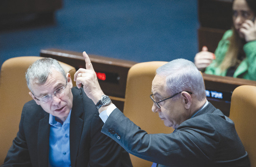  PRIME MINISTER Benjamin Netanyahu and Justice Minister Yariv Levin attend a debate and voting on the state budget bill, in the Knesset plenum, in December.  (credit: YONATAN SINDEL/FLASH90)