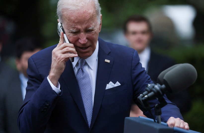  U.S. President Joe Biden speaks on a phone following an event marking National Small Business Week, in the Rose Garden of the White House in Washington, U.S., May 1, 2023. (credit: REUTERS/LEAH MILLIS)