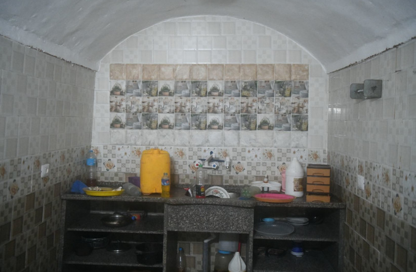   Inside view of a tunnel infrastructure, including a makeshift kitchen and a cage, in Gaza (credit: IDF SPOKESPERSON'S UNIT)
