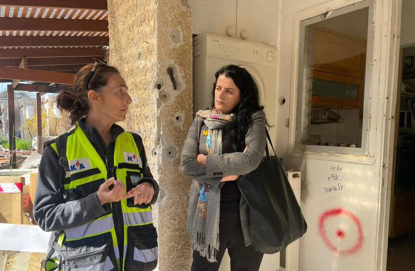   Vasfije Krasniqi Goodman  with ZAKA volunteer in Kfar Aza. (credit: SHURAT HADIN)