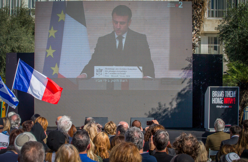  Israelis watch a screening of a ceremony attended by French President Emmanuel Macron, at Hostages Square in Tel Aviv, February 7, 2024 (credit: FLASH90)