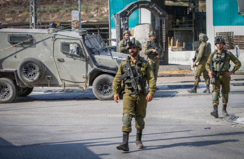 Israeli soldiers near the scene of a shooting, near the West Bank settlement of Shavei Shomron, on October 11, 2022 (credit: NASSER ISHTAYEH/FLASH90)