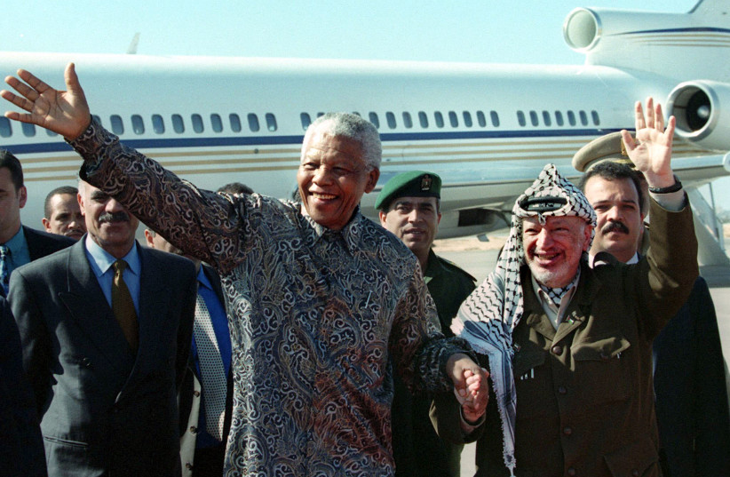  Yasser Arafat and Nelson Mandela wave upon Mandela’s arrival at Gaza airport on October 19, 1999.  (credit: REUTERS)