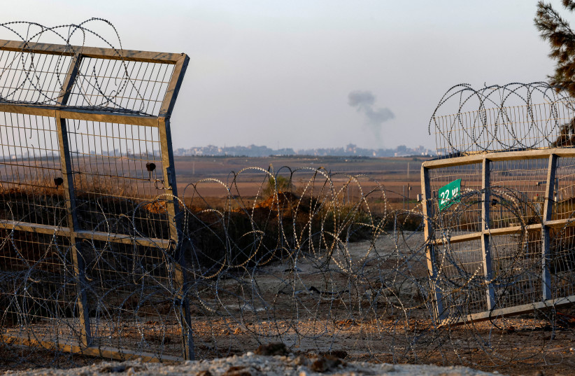  Smoke rises as seen from the broken fence in Kfar Aza where Hamas terrorists entered during the October 7tattack, in southern Israel, November 5, 2023 (credit: EVELYN HOCKSTEIN/REUTERS)