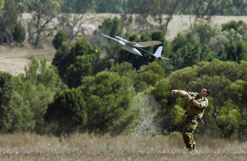  An Israeli soldier launches a Skylark unmanned aerial vehicle near the border with Gaza Strip August 4, 2014. (credit: REUTERS/NIR ELIAS)