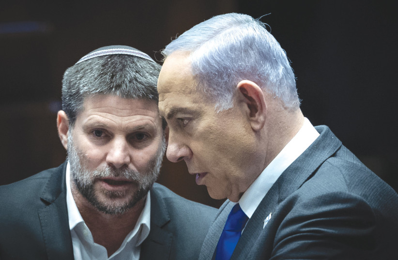  PRIME MINISTER Benjamin Netanyahu and Finance Minister Bezalel Smotrich confer in the Knesset, last week. Moody’s announcement on lowering Israel’s credit rating is viewed by both Netanyahu and Smotrich as politically motivated, the writer notes.  (credit: YONATAN SINDEL/FLASH90)