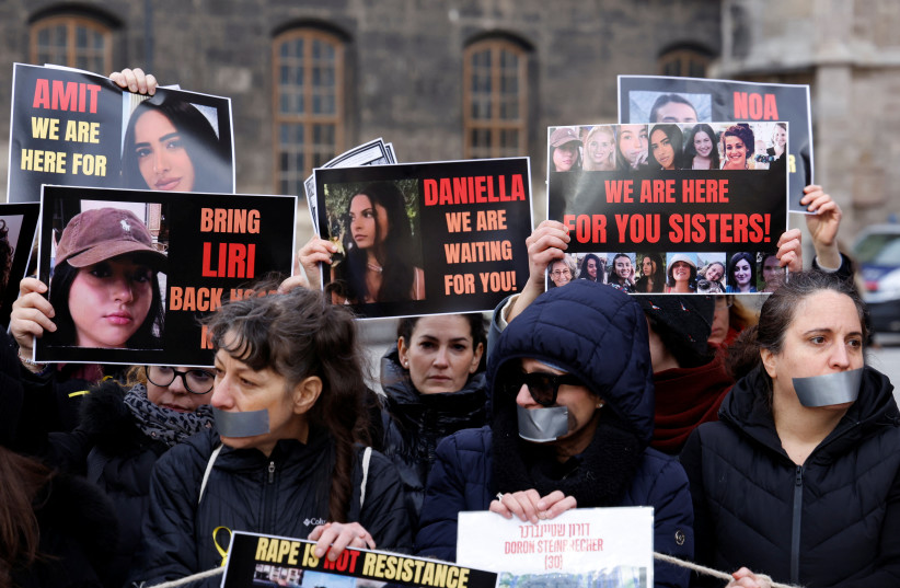 People hold posters with pictures referring to the hostages captive in Gaza, in Vienna, Austria February 13, 2024