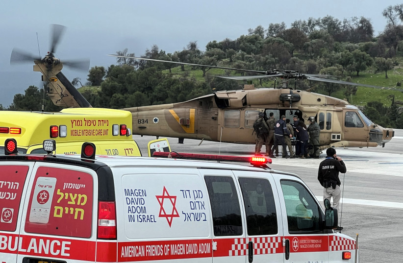  Israeli officials evacuate a person who was injured by a rocket that landed after it was fired from Lebanon, amid the ongoing conflict between Israel and the Palestinian Islamist group Hamas, in Safed, northern Israel February 14, 2024 (credit: REUTERS/Avi Ohayon)
