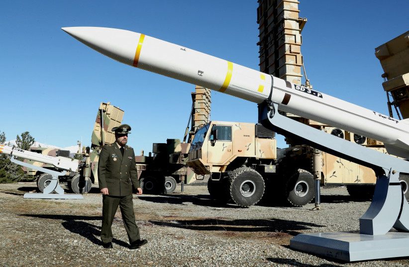  Iran's Defense Minister Brigadier General Mohammad-Reza Ashtiani walks near an Iranian missile during an unveiling ceremony in Tehran, Iran, in this picture obtained on February 17, 2024.  (credit:  Iran's Defense Ministry/WANA (West Asia News Agency)/Handout via REUTERS)