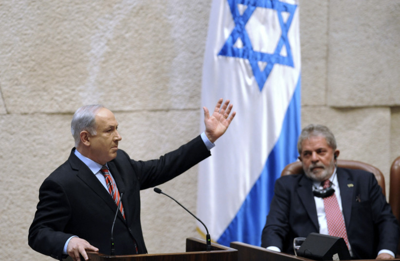  Brazil's Luiz Inacio Lula da Silva listens as Prime Minister Benjamin Netanyahu addresses the Knesset in Jerusalem, March 15, 2010 (credit: REUTERS/YIN BOGU/POOL)