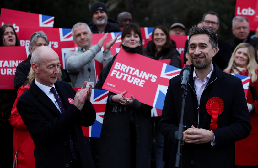 Labour Party National Campaign Co-ordinator Pat McFadden applauds Labour Party candidate Damien Egan, after he won the Kingswood Parliamentary by-election, at Kingswood Park, in Thornbury, Britain, February 16, 2024. (credit: PHIL NOBLE/REUTERS)
