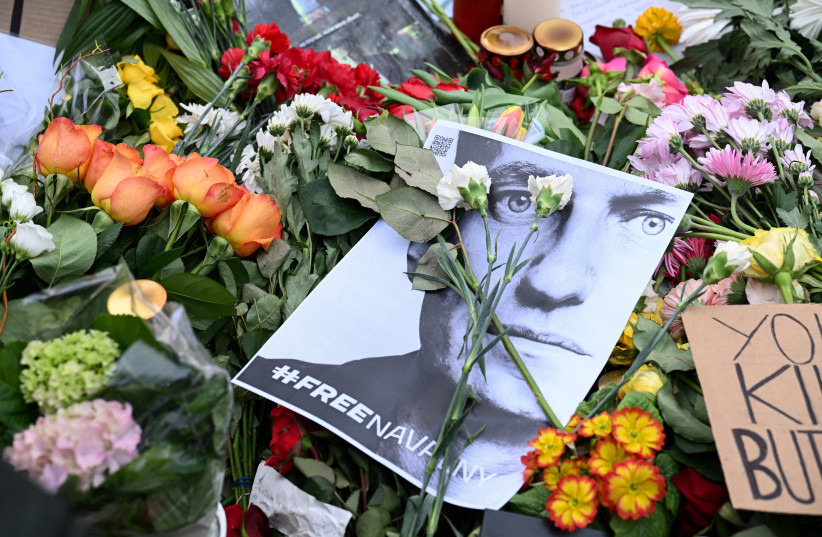  Flowers and a picture of late Russian opposition leader Alexei Navalny are left outside the Russian embassy following his death, in Berlin, Germany, February 18, 2024 (credit: ANNEGET HILSE/REUTERS)