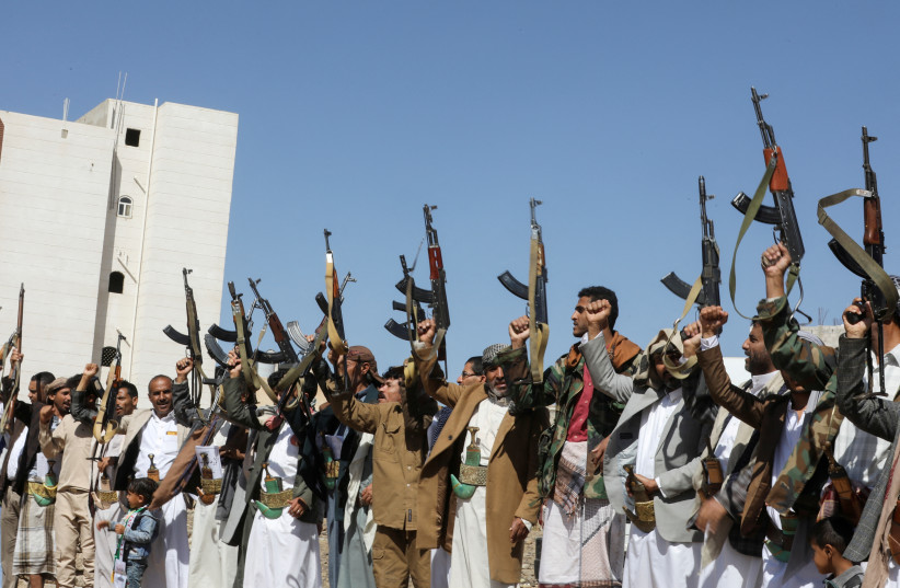  Houthi supporters hold up their rifles as they take part in a pro-Palestinian protest in Sanaa, Yemen February 18, 2024. (credit: REUTERS/KHALED ABDULLAH)