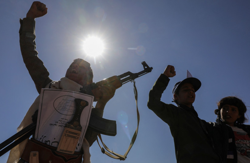  A boy holds a rifle as he takes part in a pro-Palestinian protest by Houthi supporters in Sanaa, Yemen February 18, 2024. (credit: REUTERS/KHALED ABDULLAH)