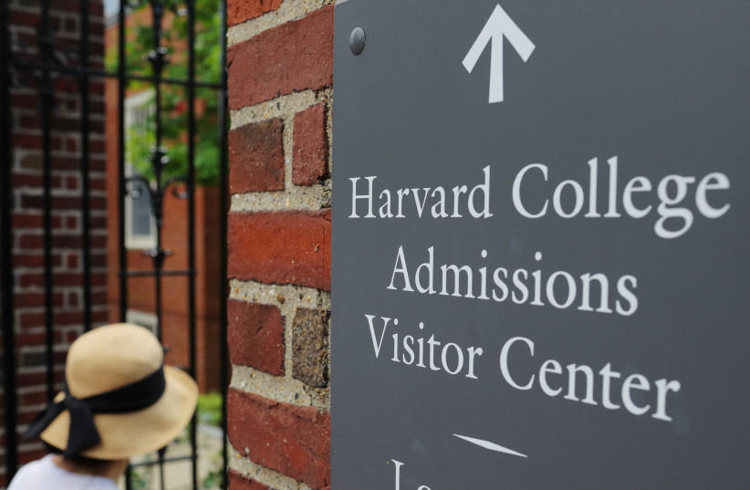  A sign points the way to the Harvard College Admissions Visitors Center at Harvard University in Cambridge, Massachusetts, U.S., July 6, 2023. (credit: BRIAN SNYDER/REUTERS)